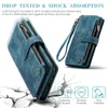 A blue leather wallet-style phone case is shown with a wrist strap and zippered compartments, presented against a background that simulates cracked ground, suggesting durability and protection. Produktbild-Vorschau