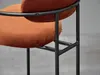 Close-up of an orange bar stool with a black metal frame. Náhľad obrázku produktu