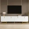 A modern white TV stand with gold accents is shown in a living room setting. Produktbild-Vorschau