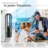 A family relaxing in a living room with a fan blowing air. Produktbild-Vorschau