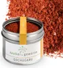 A tin of Gochugaru spice with a pile of the spice in the background. Produktbild-Vorschau
