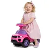 A young child is sitting on a pink toy car. Produktbild-Vorschau