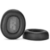 Two black ear pads for headphones are shown against a white background. One ear pad is shown from the front, displaying a textured inner surface with a logo. The other ear pad is shown from the side, highlighting its cushioned rim. Produktbild-Vorschau