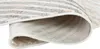 A close-up view of a rolled-up rug, showing the texture and underside. Produktbild-Vorschau