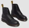 A pair of black leather Dr. Martens boots are shown against a white background. Voir les images du produit