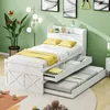 A white bed with yellow bedding and storage drawers, set in a room with green walls and a patterned rug. Produktbild-Vorschau