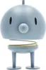 A light blue Hoptimist lamp with a spring mechanism and two legs, isolated on a white background. Produktbild-Vorschau