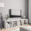 A white TV stand with shelves filled with books and decorative items, with a TV mounted on the wall above it. Voir les images du produit