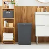 A bathroom scene with a wooden wall, a white vanity, and a wooden shelf unit. Produktbild-Vorschau