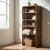 A wooden crate shelf unit filled with books, blankets, and decorative items, placed against a white brick wall near a window. Náhled obrázku produktu
