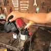 A person is using a chain sharpener in a workshop. Produktbild-Vorschau