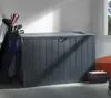 A dark gray storage box with a golf bag next to it, in a room with a window. Podgląd zdjęcia produktu