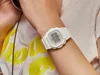 A person wearing a white Casio Baby-G watch on their wrist, with part of a white t-shirt with a yellow graphic visible. Produktbild-Vorschau