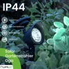 A solar garden spotlight is shown in a garden setting with rain falling. Produktbild-Vorschau