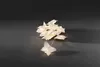 A pile of white paper butterfly-shaped lights on a dark gray surface. Náhled obrázku produktu