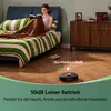 A person is reading a book on a bed while a robot vacuum cleaner operates on the floor. Produktbild-Vorschau