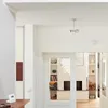 Interior view of a hallway and living room with shelves and a fireplace. Produktbild-Vorschau