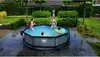 Children playing in a round swimming pool in a backyard. Náhled obrázku produktu