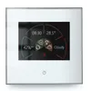 A digital thermostat with a touch screen displaying time, temperature, humidity, and weather information. Produktbild-Vorschau
