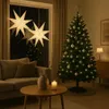 A cozy living room decorated for Christmas, featuring a Christmas tree, sofa, coffee table, and window decorations. Podgląd zdjęcia produktu