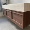 A floating vanity with a stone countertop and wooden drawers. Anteprima dell’immagine prodotto