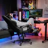 A person relaxing in a gaming chair in a room with a computer setup. Produktbild-Vorschau