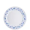 A white plate with a blue floral pattern around the rim. Produktbild-Vorschau