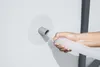 A hand is inserting a flexible hose into a wall fitting. Náhľad obrázku produktu