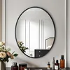 A vanity table with a mirror, flowers, and cosmetics. Produktbild-Vorschau