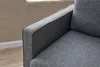 A close-up view of the armrest and seat of a grey sofa. Produktbild-Vorschau