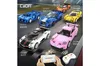 A collection of colorful toy sports cars displayed on a race track background, with a smartphone and remote control in the foreground. Voir les images du produit