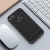 A black phone case is shown on a desk next to a computer mouse and keyboard. Produktbild-Vorschau