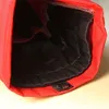 A close-up view inside a red bag with a black lining. Produktbild-Vorschau