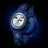 A close-up studio shot of a blue Swatch x Omega MoonSwatch watch against a dark blue background. Produktbild-Vorschau