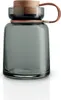 A glass storage jar with a wooden lid and leather strap. Voir les images du produit