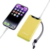A smartphone is being charged by a yellow power bank. Voir les images du produit