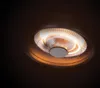 A close-up, low-angle shot of a ceiling-mounted industrial heater with glowing heating elements. Produktbild-Vorschau