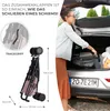 A woman is loading a folded stroller into the trunk of a car. The stroller is pink and black. Náhled obrázku produktu