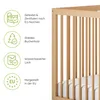 A close-up view of a wooden baby crib with informational icons and text on the left side. Produktbild-Vorschau