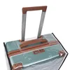 A close-up shot of the top of a teal suitcase covered in a transparent protective sleeve. Náhľad obrázku produktu
