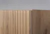 A close-up view of the corner of a wooden cabinet with a fluted front panel and a plain side panel. Náhľad obrázku produktu
