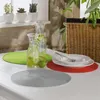 A table setting with placemats, water pitchers, and plants. Produktbild-Vorschau