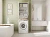 A modern bathroom with a washing machine cabinet, bathtub, and vanity. Anteprima dell’immagine prodotto