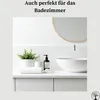 A clean and modern bathroom vanity with a sink, faucet, soap dispenser, plant, and folded towel. Anteprima dell’immagine prodotto