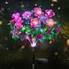 A solar-powered string of lights shaped like purple and pink flowers with green leaves, set against a dark, bokeh-filled background. Náhled obrázku produktu