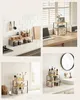 Collage of four images showing a 2-tier shelf unit used for organizing kitchen items, office supplies, and bathroom toiletries. Produktbild-Vorschau