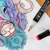 A close-up of a coloring page with markers. Náhľad obrázku produktu