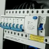 A close-up view of an electrical distribution box with multiple circuit breakers and sockets. Produktbild-Vorschau