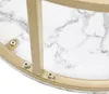 Close-up view of the underside of a round table with a marble-patterned surface and gold metal legs attached with screws. Voir les images du produit