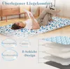A woman is lying on a futon mattress on the floor, reading a book. The mattress has a blue and white floral pattern. There are also diagrams and text overlays highlighting product features. Náhled obrázku produktu